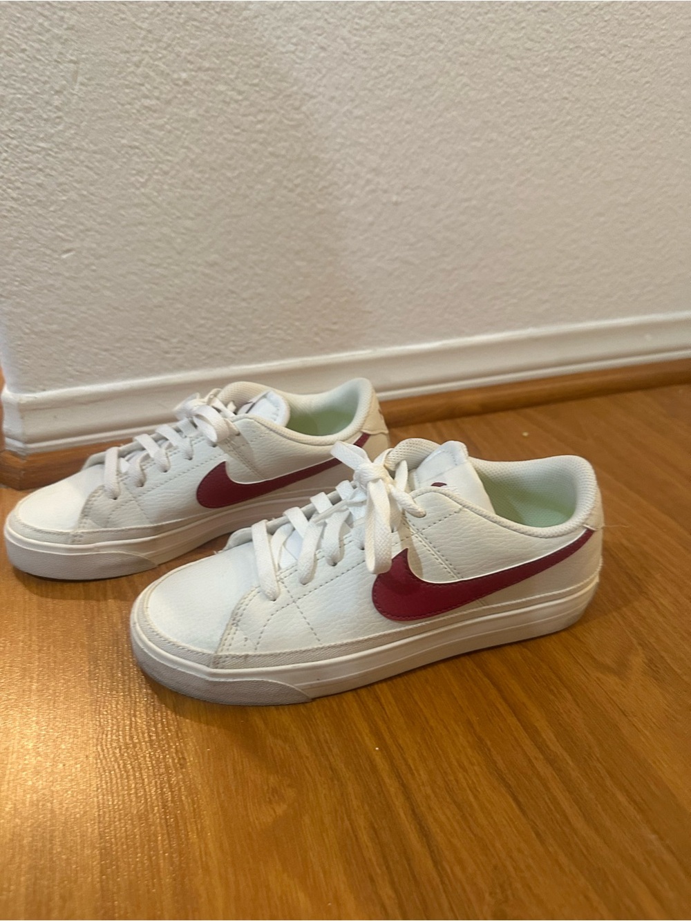 Nike White Sneakers with Red Swoosh Accent
